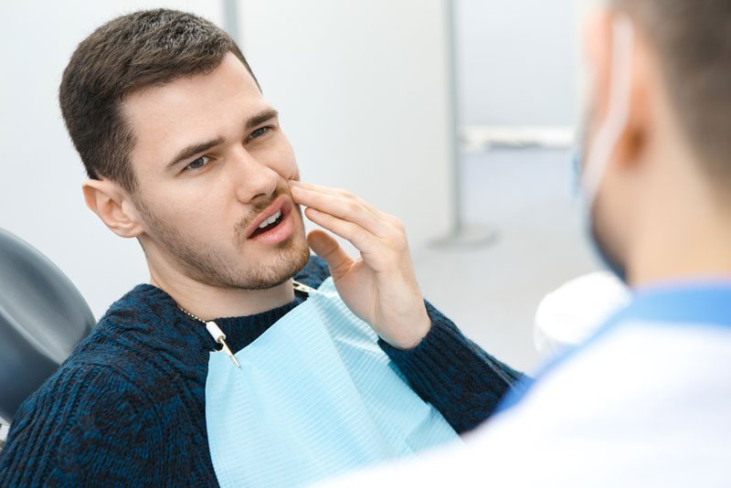 Dental Patient Suffering From Mouth Pain On A Dental Chair, In San Francisco, CA